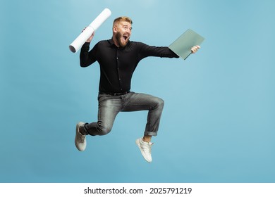 Hurrying up to finish task, object. Cute funny bearded man, builder, designer or architect with professional equipment jumping isolated on white background. Concept of occupation, job, motivation