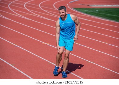 Hurts Too Much. Male Trauma. Sportsman Athlete Flex Muscles And Knead A Joint. Man Has Injury After Exercise On Stadium. Fitness Gym Outdoor. Muscular Athletic Guy With Bruise. Sport Training