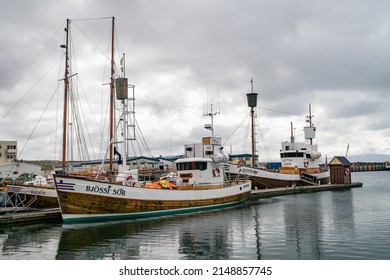 Husavik, Iceland - June 2019: Traditional old wooden fisherman boats used for whale watching in Husavik harbor