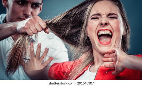 Husband abusing wife pulling her hair. Afraid and scared woman screaming, shouting and crying. Domestic violence aggression.