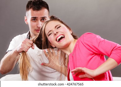 Husband abusing wife pulling her hair. Afraid and scared woman screaming, shouting and crying. Domestic violence aggression.