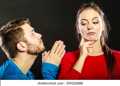 Husband Apologizing Wife. Man Asking Woman For Forgivness. Boyfriend Trying To Convince Girlfriend. Conflicted Couple In Studio On Black. Relationship Problem.