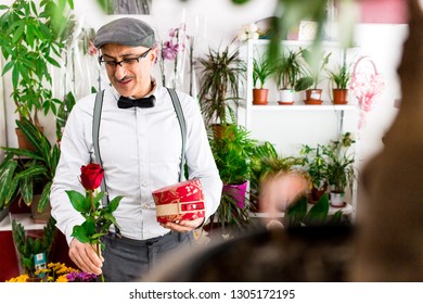 Husband Buying Flowers And Gifts For Valentine's Day For His Wife In Local Flower Shop, Not Sure If He Made The Right Choice