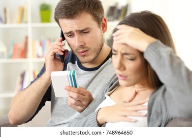 Husband Calling Doctor Asking About Wife Medicine Allergy Or Side Effects Sitting On A Sofa In A House Interior