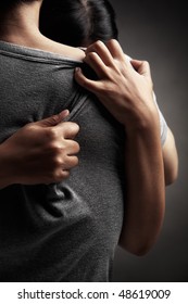 A Husband Embrace Her Sad Wife, In Dark Background Theme