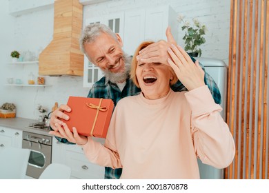 husband gives a gift to her wife at home - Powered by Shutterstock