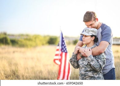 Husband hugs wife in the army