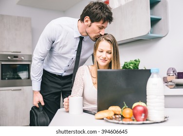 Husband Kissing Goodbye To His Wife Before Going To Work