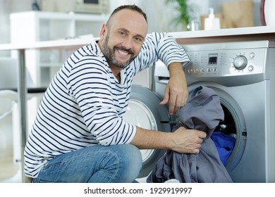 Husband Man Doing Laundry At Home