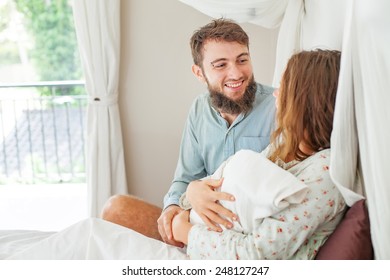 Husband Supports His Wife After A Childbirth