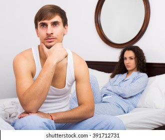 Husband turning away from wife during bad fight in bedroom