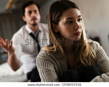 Husband and wife are arguing at home. Angry man is yelling at his wife
