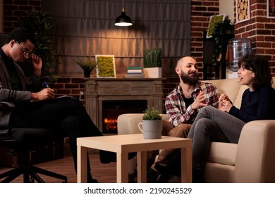 Husband And Wife Attending Couple Therapy Session With Male Therapist, Trying To Solve Relationship Problems And Fighting With Advice And Help. Asking For Support With Marriage Difficulties.