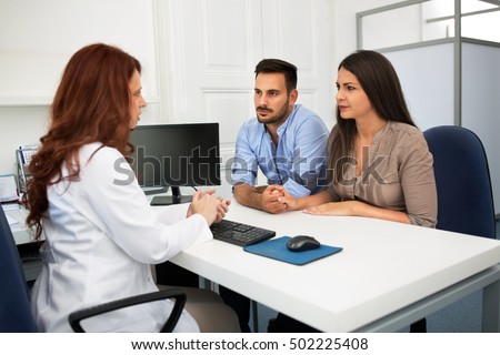 Husband and wife in a clinic, Beautiful young couple at pregnancy consultation period Stock photo © 