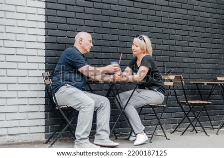 husband and wife are drinking coffee at the table
