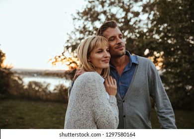 Husband and wife enjoying sunset - Shutterstock ID 1297580164
