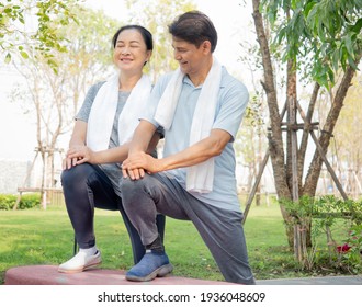 Husband And Wife Happy Jogging Outdoor Sport. Middle Aged Housewife Does Stretching As Her Senior Husband Coach. Asian Couple Exercising In Nature Park Together. Vitality Family Togetherness Concept.