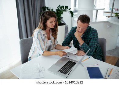 Husband And Wife Preparing Bills To Pay. Young Couple Having Financial Problems.	

