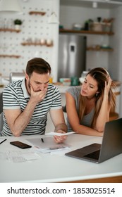 Husband And Wife Preparing Bills To Pay. Young Couple Having Financial Problems	