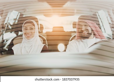 Husband And Wife Are Sitting In A New Car And Smiling. Young Arab Family Went To A Car Dealership To Choose A New Car.