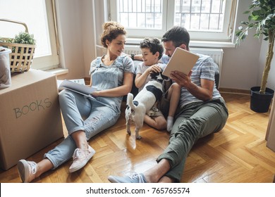 Husband and wife and their son and a pet moving in new home. - Powered by Shutterstock