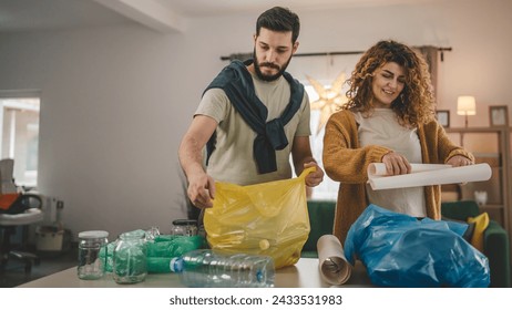 husband and wife woman and man family recycle at home sorting waste plastic paper and glass to green, yellow and blue bags sustainable living concept - Powered by Shutterstock