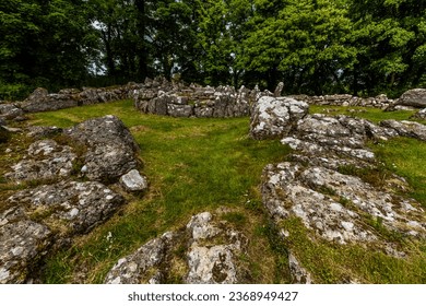 hut circle in Remains of Din Lligwy, or Din Llugwy ancient village, Near Moelfre, Anglesey, North Wales, UK, landscape, wide, angle, stone in foreground, wideangle.