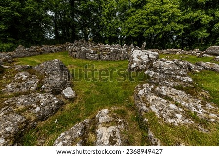 hut circle in Remains of Din Lligwy, or Din Llugwy ancient village, Near Moelfre, Anglesey, North Wales, UK, landscape, wide, angle, stone in foreground, wideangle.