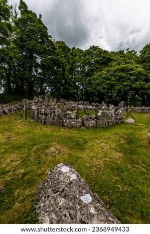 hut circle in Remains of Din Lligwy, or Din Llugwy ancient village, Near Moelfre, Anglesey, North Wales, UK, portrait, wide, angle, stone in foreground, wideangle.