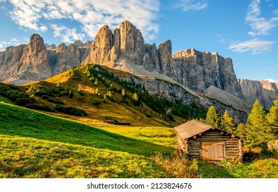 A hut in a mountain valley. Mountain cabin view. Mountainside cabin landscape. Cabin in mountains