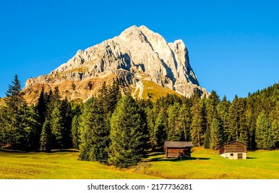 A hut in a mountain valley. Forest farm in mountains. Mountain cabin view. Mountain peak landscape