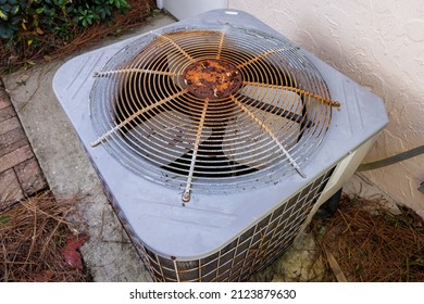 HVAC Air Conditioner In Need Of Repair. Top View Of Old Rusty AC Unit Fan.