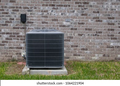 HVAC Air Conditioning Unit On Concrete Slap With New Construction Brick House