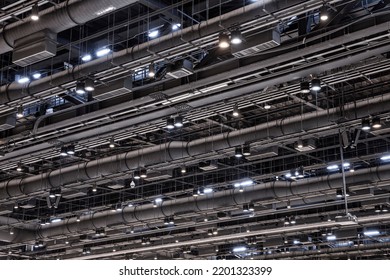 HVAC Duct Cleaning, Ventilation Pipes In Silver Insulation Material Hanging From The Ceiling Inside New Building.