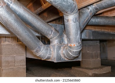 HVAC ductwork, air duct, in crawlspace of house. Duct cleaning, furnace repair and home maintenance concept.