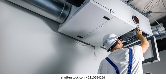 hvac engineer install heat recovery ventilation system for new house. copy space - Shutterstock ID 2110384256