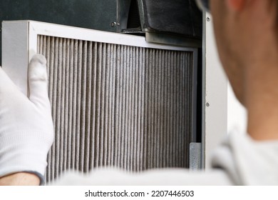 hvac filter replacement home central air system. servicemen changing filter in furnace. Change filter in rotary heat exchanger recuperator. - Shutterstock ID 2207446503
