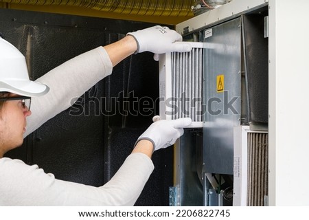 hvac filter replacement home central air system. servicemen changing filter in furnace. Change filter in rotary heat exchanger recuperator.