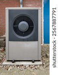 HVAC heat pump unit in a residential outdoor area, showcasing sustainable energy technology for efficient heating and cooling.