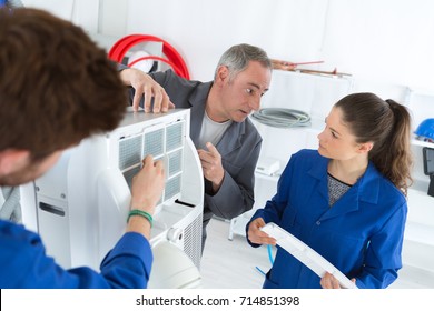 Hvac Repair Technicians Working On Commercial Heating Air Conditioning Unit