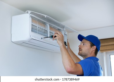 Hvac Services - Technician Installing Air Conditioner On The Wall At Home