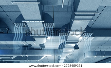 HVAC systems, building ventilation. Ceiling air ducts distribute airflow through grilles, supporting climate control, air circulation, and mechanical engineering of commercial interiors.