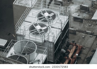 HVAC Systems, Cooling and Heating Equipment for Building. Air conditioner compressor installed on the roof of a building with industrial air conditioning units.