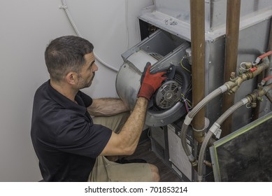 Hvac Tech Installing A Blower Motor Into A Water Based Heat Pump