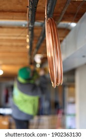 HVAC Technician Installing Copper Pipe For New Furnace Installation. 