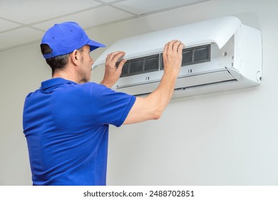 Hvac technician performing air conditioner maintenance inspection. 24 hours emergency breakdowns and failures repair service. Home insurance. - Powered by Shutterstock