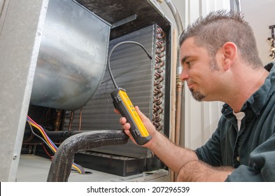 An Hvac Technician Searching For A Refrigerant Leak On An Evaporator Coil. 