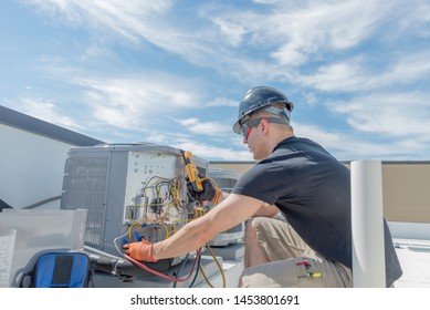 Hvac Technician Servicing A Rooftop Condensing Unit