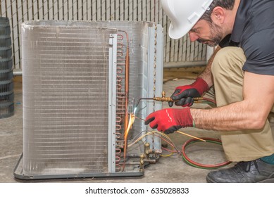 HVAC Technician Soldering A Copper Joint On A Condensing Coil. 