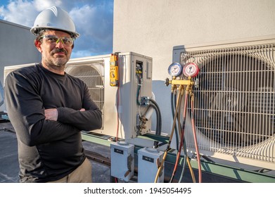 HVAC technician standing next to mini-split air conditioner units